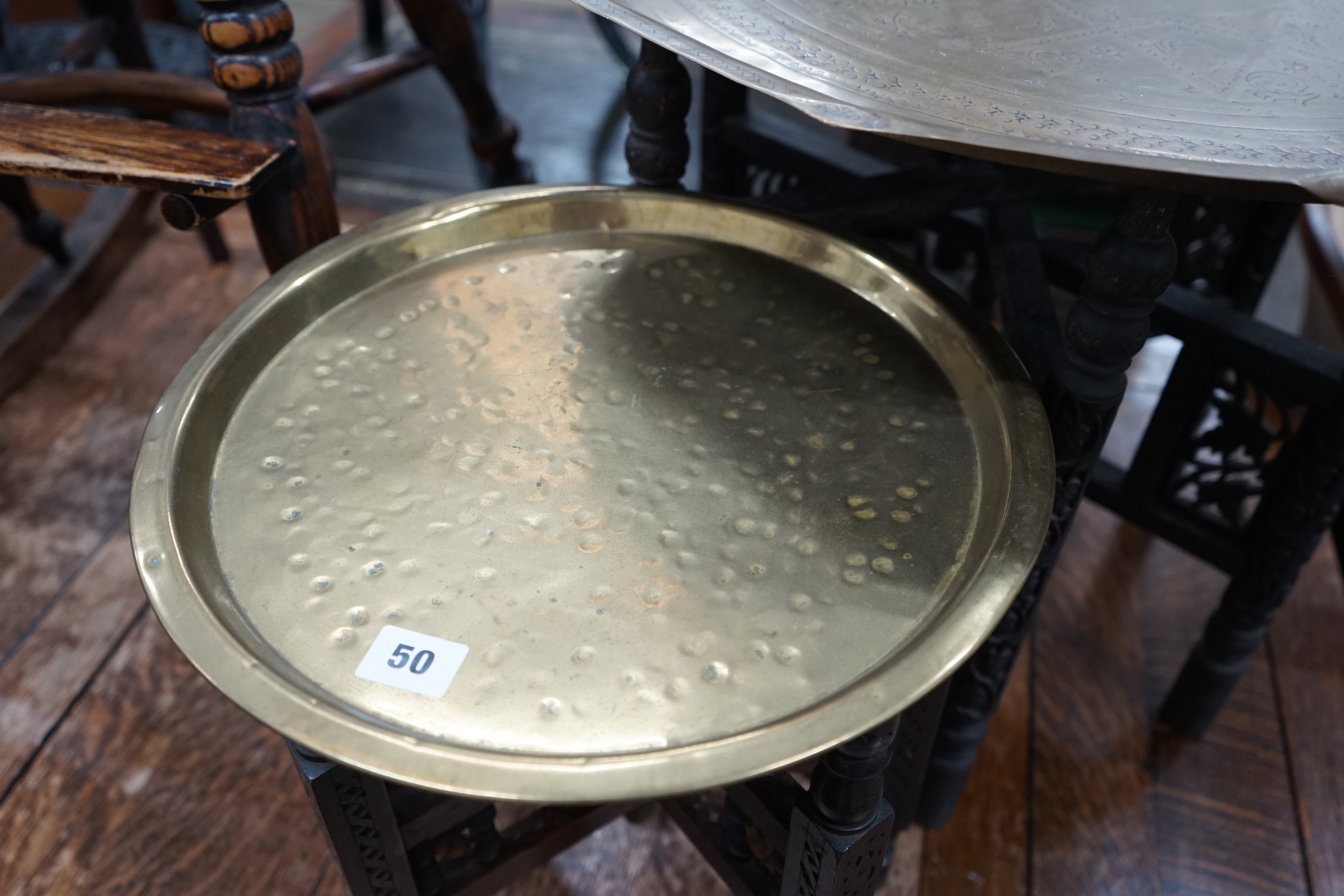 Two Indian brass tray top folding tables, largest width 56cm height 49cm